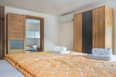 a bedroom with a bed with two towels on it at Vila Jelena Gorje, Vintgar, Bled in Zgornje Gorje