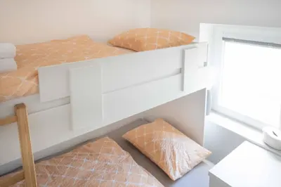 two beds with pillows and a shelf in a room at Vila Jelena Gorje, Vintgar, Bled in Zgornje Gorje