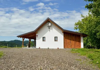 a white building with a brown roof at Gold Wine Estate in Podlehnik