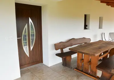 a room with a wooden table and a wooden door at Gold Wine Estate in Podlehnik