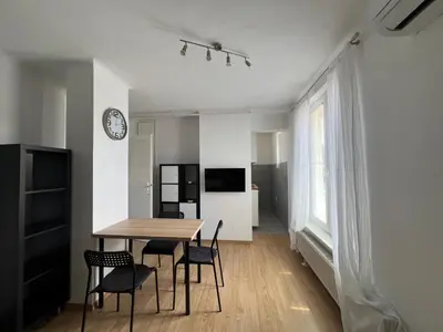 a kitchen and dining room with a table and chairs at Tabor in Ljubljana