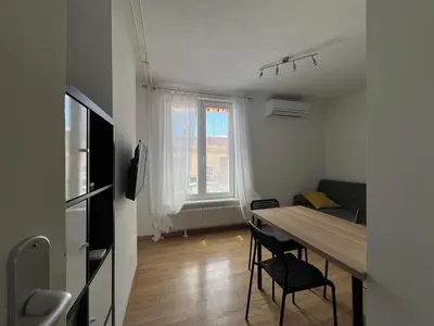a room with a table and chairs and a bedroom at Tabor in Ljubljana