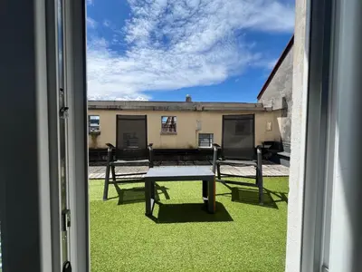a view of a table and benches from a window at Tabor in Ljubljana