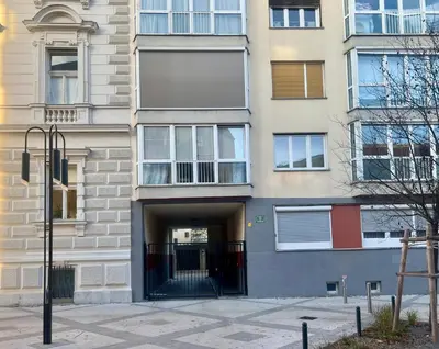 an apartment building with a gate in the entrance at Tabor in Ljubljana