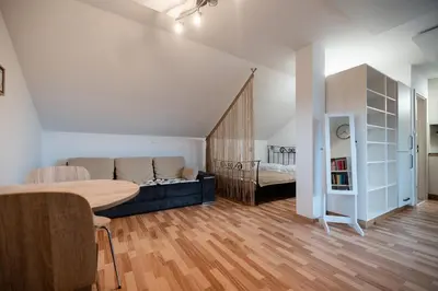 a living room with a couch and a bed at Apartma Angelika in Mozirje