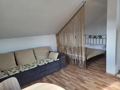 a living room with a couch and a bed at Apartma Angelika in Mozirje