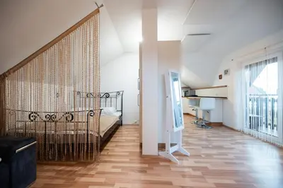 a bedroom with a bed and a large window at Apartma Angelika in Mozirje