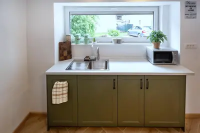 a kitchen with a sink and a window at K&M apartments Bled in Bled