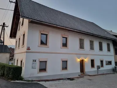a white house with a black roof at K&M apartments Bled in Bled