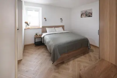 a bedroom with a bed and a window at K&M apartments Bled in Bled