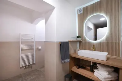 a bathroom with a sink and a mirror at K&M apartments Bled in Bled