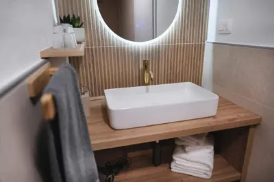 a bathroom with a white sink and a mirror at K&M apartments Bled in Bled
