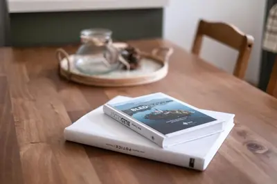 two books sitting on top of a wooden table at K&M apartments Bled in Bled