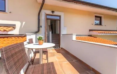 a balcony with a table and chairs on a building at 4 Bedroom Beautiful Home In Sezana in Sežana