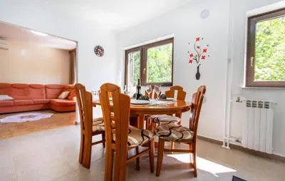 a kitchen and dining room with a table and chairs at 4 Bedroom Beautiful Home In Sezana in Sežana