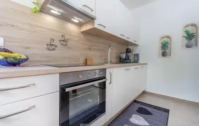 a kitchen with white cabinets and a stove at 4 Bedroom Beautiful Home In Sezana in Sežana