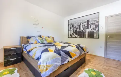 a bedroom with a bed and a picture on the wall at 4 Bedroom Beautiful Home In Sezana in Sežana