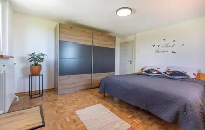 a bedroom with a bed and a large sliding door at 4 Bedroom Beautiful Home In Sezana in Sežana