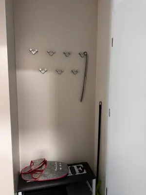 a room with a white wall with hooks on the wall at U Izi 2 in Kranjska Gora