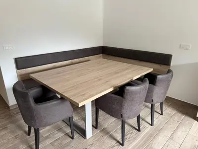 a wooden table with four chairs around it at U Izi 2 in Kranjska Gora