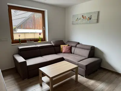 a living room with a couch and a table at U Izi 2 in Kranjska Gora
