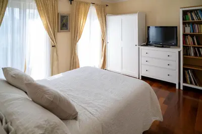 a bedroom with a bed and a tv on a dresser at Hiša pri poetu in Šempeter pri Gorici