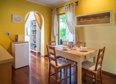 a kitchen and dining room with a table and chairs at Hiša pri poetu in Šempeter pri Gorici