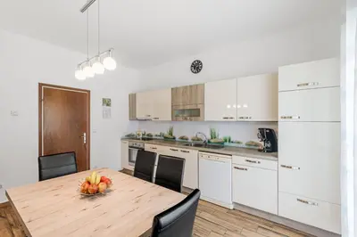 a kitchen with a wooden table with a bowl of fruit on it at Apartment Stella with Two Bedrooms & Free Parking Spot in Bovec