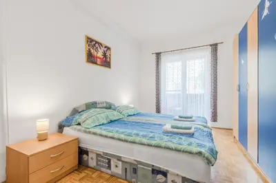 a bedroom with a bed and a window at Apartment Stella with Two Bedrooms & Free Parking Spot in Bovec