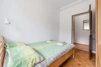 a bedroom with a bed with a green comforter at Apartment Stella with Two Bedrooms & Free Parking Spot in Bovec