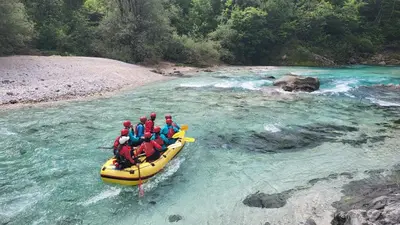 a group of people in a raft on a river at Apartment Stella with Two Bedrooms & Free Parking Spot in Bovec