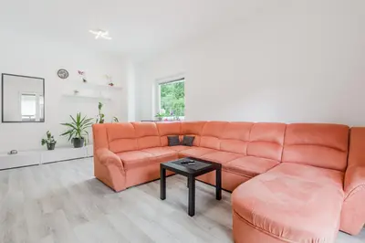 a living room with a orange couch and a table at Apartment Stella with Two Bedrooms & Free Parking Spot in Bovec
