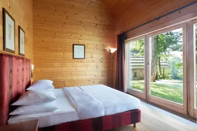 a bedroom with a bed and a large window at Posestvo Pule Equestrian Estate in Trebelno