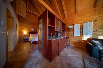 a room with a room with a bed in a wooden cabin at Posestvo Pule Equestrian Estate in Trebelno