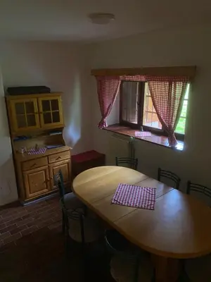a kitchen with a wooden table and a window at Koča na Kranjski dolini Krnica 93 a,Pokljuka in Zgornje Gorje