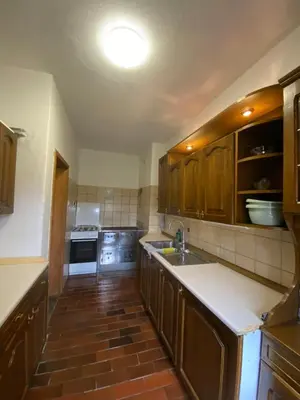 a kitchen with wooden cabinets and a kitchen sink at Koča na Kranjski dolini Krnica 93 a,Pokljuka in Zgornje Gorje