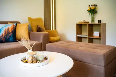 a living room with a coffee table and a couch at Apartma pod macesnom in Jesenice