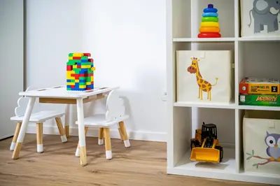 a table and two chairs and a table and a shelf at Apartma pod macesnom in Jesenice