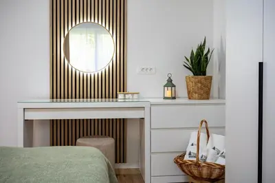 a bedroom with a dressing table and a mirror at Apartma pod macesnom in Jesenice