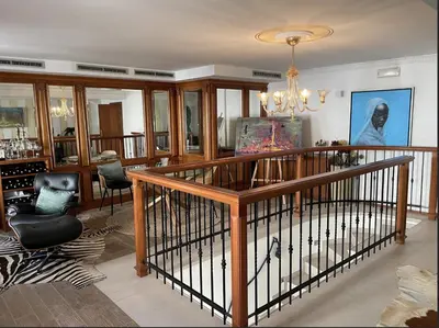 a living room with a chandelier and a staircase at Art apartment Kranj in Kranj