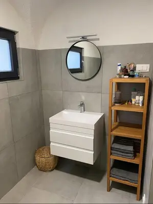 a bathroom with a white sink and a mirror at Art apartment Kranj in Kranj