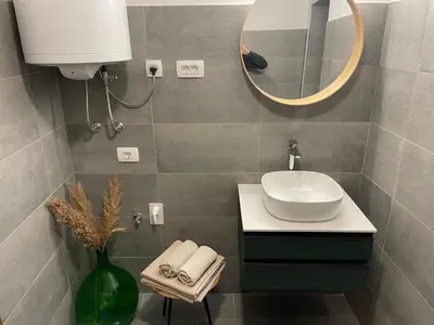 a bathroom with a sink and a mirror at Art apartment Kranj in Kranj