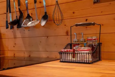 a kitchen with utensils hanging on a wooden wall at Chalet Guapa in Bohinj