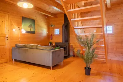 a living room with a couch and a staircase at Chalet Guapa in Bohinj