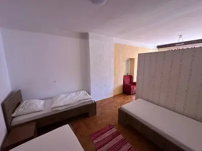 a room with two beds and a couch in it at Apartma Pri Kosu in Slovenska Bistrica