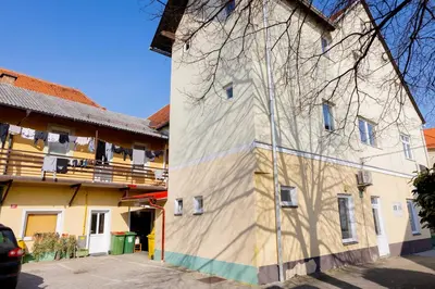 a building with a shadow on the side of it at Apartma Pri Kosu in Slovenska Bistrica