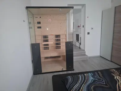 a living room with a large glass window in a room at Tabor View Apartment in Maribor