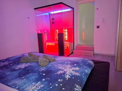 a bedroom with a bed and a red light at Tabor View Apartment in Maribor