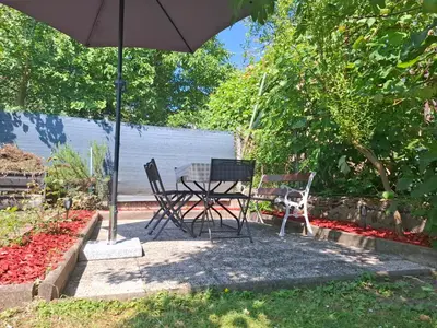 a table and chairs sitting under an umbrella at Tabor View Apartment in Maribor
