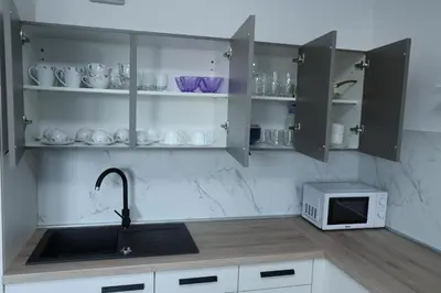 a kitchen with a sink and a microwave at Tabor View Apartment in Maribor